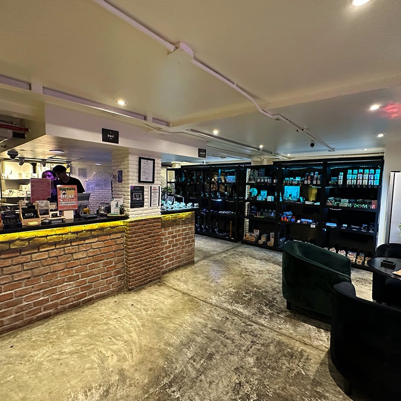 Inside FOURTWENTY The Loft Sukhumvit 22 with the brick counter and product display wall.