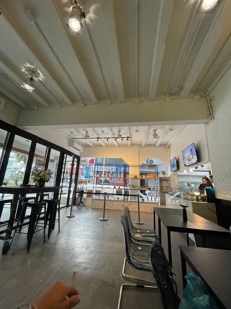Wide interior view of FOURTWENTY Asoke with the bright seating and showroom floor.