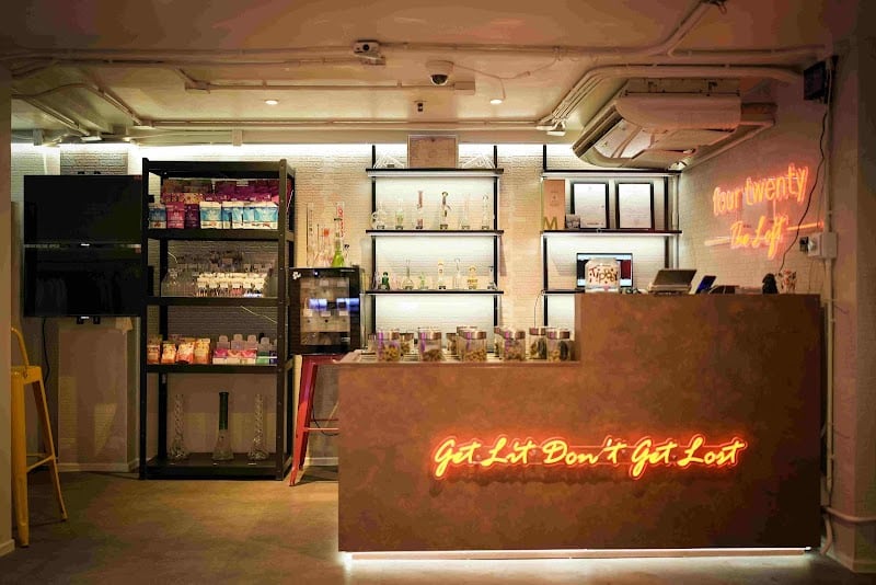 The Loft Sukhumvit 22 lounge counter with FOURTWENTY neon signage.